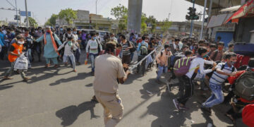 Migrant workers pelt stones at police near IIM in Ahmedabad, 100 detained