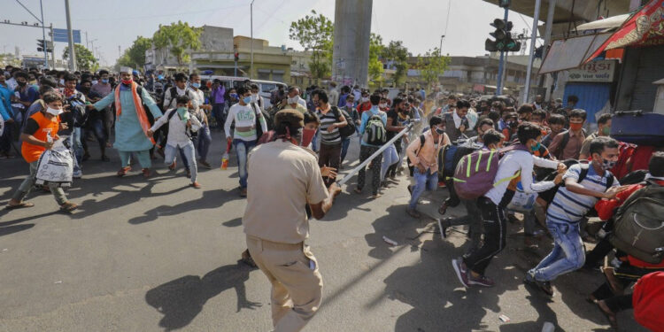 Migrant workers pelt stones at police near IIM in Ahmedabad, 100 detained