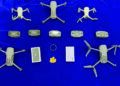 Drones, iPhones, gold seized at airport; one held