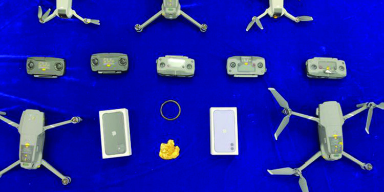 Drones, iPhones, gold seized at airport; one held