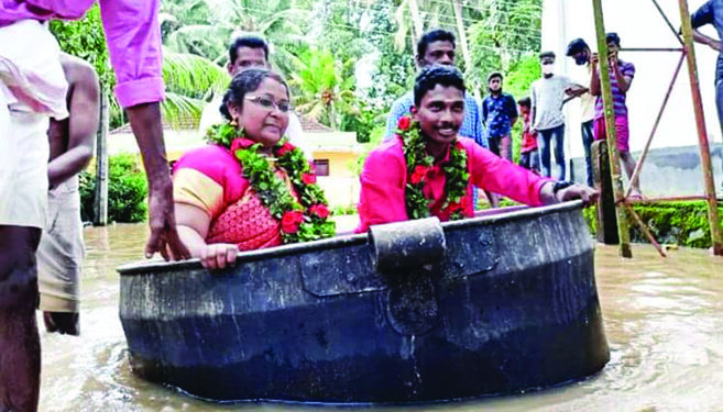 Brave bride, groom travel in cooking vessel, get married amidst rising floods in God’s Own Country