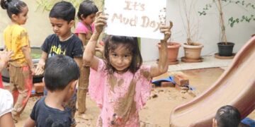 Nurture Preschool, South Bopal, kids have fun with mud on International Mud Day